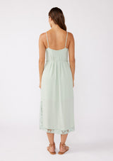 [Color: Mint] A brunette model wearing a mint green midi dress with a floral lace trim. A casual dress with adjustable spaghetti straps, scoop neckline, tie waist detail, and side slits. An ultra flowy midi dress for the summer and beyond.