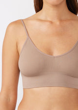 [Color: Mocha] A brunette model wearing a fitted crop lingerie top in brown. A casual yet stylish undergarment perfect for styling under dresses or wearing on it's own as a sports bra. A comfortable stretchy ribbed knit top with a low back and spaghetti straps.