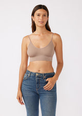 [Color: Mocha] A brunette model wearing a fitted crop lingerie top in brown. A casual yet stylish undergarment perfect for styling under dresses or wearing on it's own as a sports bra. A comfortable stretchy ribbed knit top with a low back and spaghetti straps. 