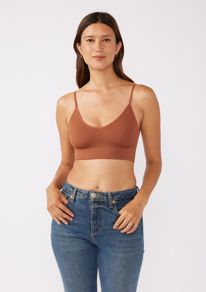 [Color: Chocolate] A brunette model wearing a fitted crop lingerie top in dark brown. A casual yet stylish undergarment perfect for styling under dresses or wearing on it's own as a sports bra. A comfortable stretchy ribbed knit top with a low back and spaghetti straps.