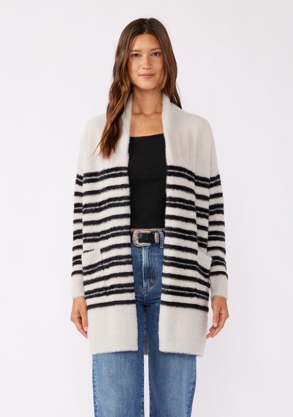 [Color: Grey/Black] A brunette model wearing a fuzzy mid length cardigan with mirrored black stripes. A soft long sleeve cardigan with an open front, shawl collar, and patch pockets. An everyday sweater for the fall season. 