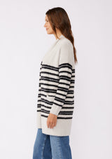 [Color: Grey/Black] A brunette model wearing a fuzzy mid length cardigan with mirrored black stripes. A soft long sleeve cardigan with an open front, shawl collar, and patch pockets. An everyday sweater for the fall season. 