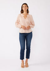 [Color: Dusty Rose] A front facing image of a brunette model wearing a pretty boho blouse in a dusty pink. With floral tonal embroidery, lace trim inserts, long sleeves with smocked wrist cuffs, and a split v neckline. An airy and relaxed fit blouse crafted in a cotton blend fabric. 