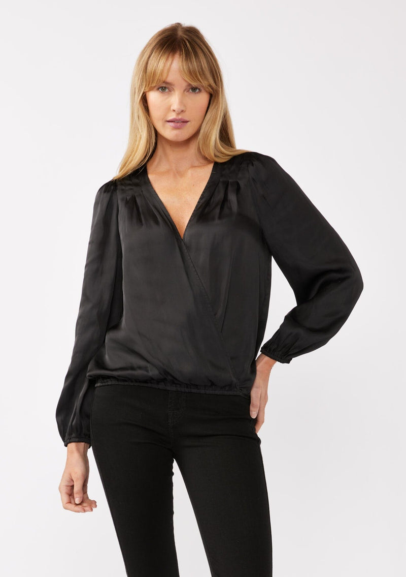 [Color: Black] A front facing image of a blonde model wearing a holiday black silky polyester satin top. This special occasion top features a surplice v neckline, front hook and eye closure, elastic hemline, and long sleeves. Perfect for Christmas and holiday parties. 