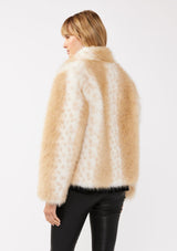 [Color: Natural] A back facing image of a blonde model wearing a tan brown stripe, dotted fur faux coat with an all black outfit. Featuring a high collar, open front, and long sleeves. A cold weather style, perfect for any special occasion. 