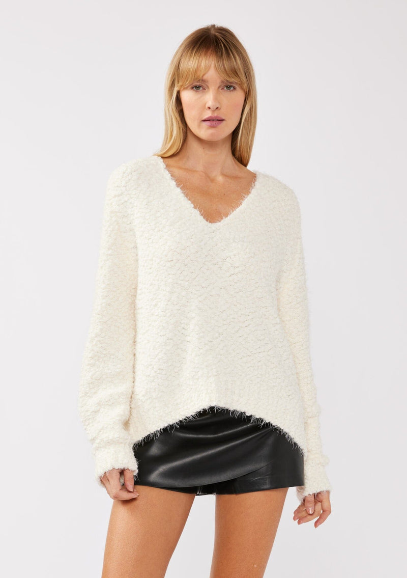 [Color: Antique White] A front-facing image of a blonde model wearing a green cozy, fuzzy popcorn-textured pullover sweater with long sleeves, a classic V-neckline, and a high-low hemline. Ideal for lounging or casual fall outings.