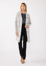 [Color: Cream/Black] A full body front facing image of a blonde model wearing a fuzzy statement sweater coat in a cream and black plaid print. With long sleeves, a notched collar, a snap button front, and side patch pockets. 