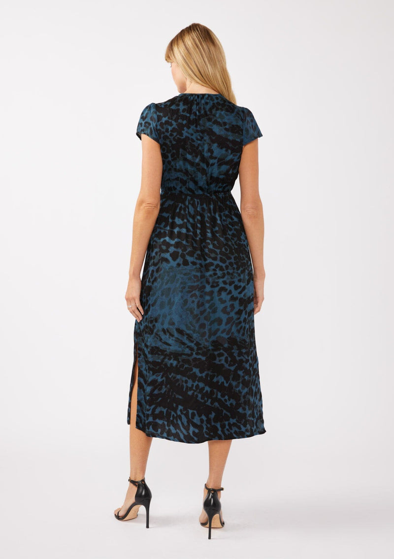 [Color: Midnight/Black] A full body back facing image of a blonde model wearing a black and blue leopard print maxi dress. With a deep v neckline, short sleeves, elastic waistline, and side slits. A versatile holiday dress, perfect for casual outings and special occasions. 