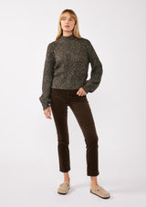 [Color: Black Multi] A full body front facing image of a blonde model wearing a chunky multi color knit sweater with a mock neckline and long voluminous sleeves. 