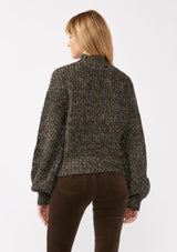 [Color: Black Multi] A back facing image of a blonde model wearing a chunky multi color knit sweater with a mock neckline and long voluminous sleeves. 