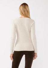 [Color: Heather Stone] A back facing image of a blonde model wearing a classic body hugging pullover sweater in off white. With a classic square neckline, long sleeves, and a straight hem. Styled with corduroy bottoms for a laid-back cool girl fall ensemble.   