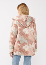 [Color: Brick/Cream] A back facing image of a blonde model wearing a popular floral jacket with sherpa lining. This cozy fall and winter jacket features long sleeves, patch pockets, and a hoodie, draped for all-day comfort and warmth. Ideal for colder temperatures.