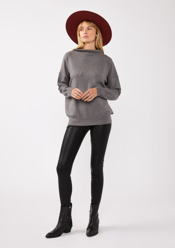 [Color: Heather Charcoal] A blonde model wearing a grey cozy lightweight pullover with a mock neckline. Complete with long sleeves, dropped shoulders, and a snugged ribbed trim. Perfect for layering or styling on its own for a relaxed, laid-back fall look. 