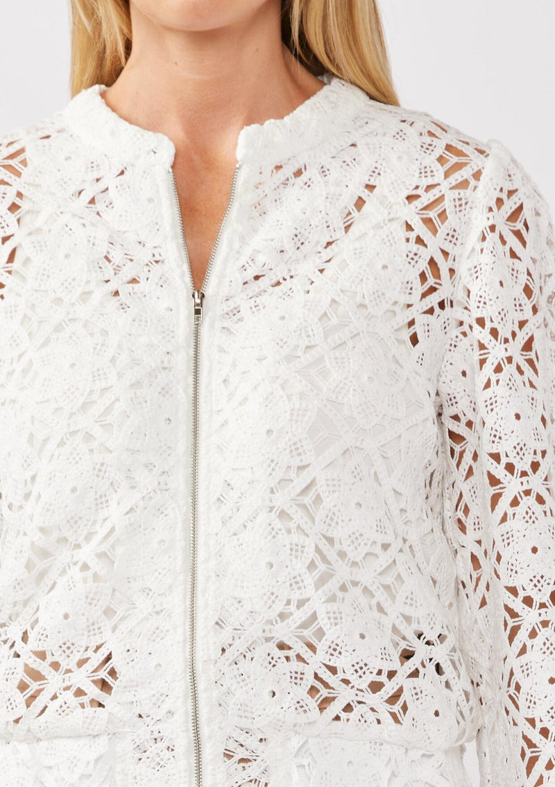 [Color: White] A detail image of a blonde model wearing a white open crochet bomber jacket. The jacket features a floral lace pattern, a zip-up front, and a wide elastic band at the hem and cuffs. This cropped style is perfect for casual outings on vacation or as a beachwear throw on.