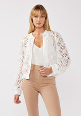 [Color: White] A front-facing image of a blonde model wearing a white open crochet bomber jacket. The jacket features a floral lace pattern, a zip-up front, and a wide elastic band at the hem and cuffs. This cropped style is perfect for casual outings on vacation or as a beachwear throw on.