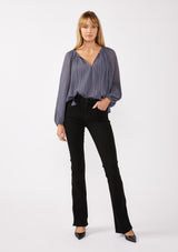 [Color: Slate Blue] A front facing image of a blonde model wearing a blue pleated chiffon blouse. Featuring a split v-neckline with tie detail, long sleeves, and elastic cuffs. A flowy, relaxed top for the office or special occasions. 