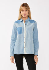 [Color: Denim] A front facing image of a blond model wearing a unique color block button down shirt in denim blue. Featuring a classic button front, long sleeves, button wrist closure, and collared neckline. Perfect for fall styling. 