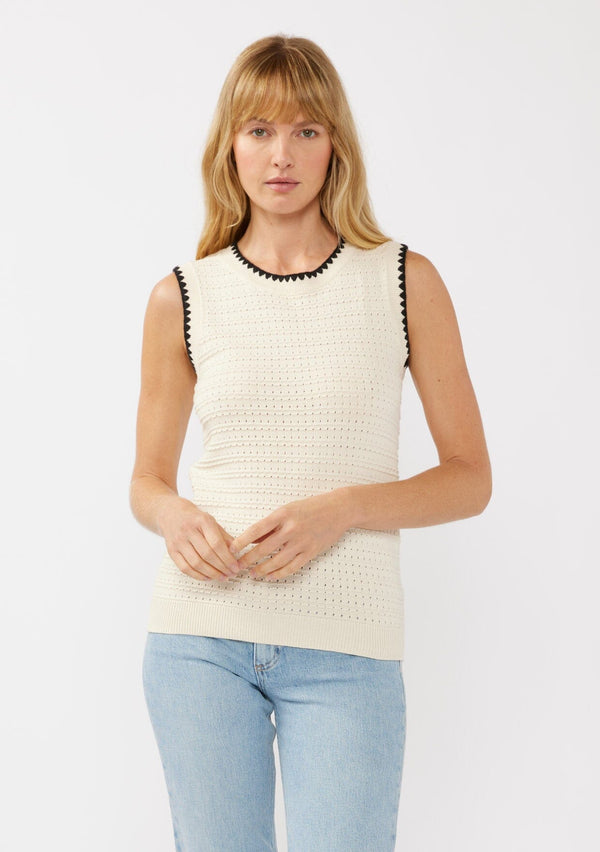 [Color: Natural/Black] A front facing image of a blonde model wearing an off white knit sweater vest with a stripe knit texture. A casual throw-on with a round neckline, black contrast stitch trim, and a ribbed hem. Perfect for layering or wearing on its own. 