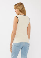 [Color: Natural/Black] A back facing image of a blonde model wearing an off white knit sweater vest with a stripe knit texture. A casual throw-on with a round neckline, black contrast stitch trim, and a ribbed hem. Perfect for layering or wearing on its own. 