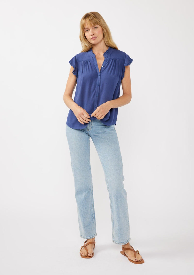 [Color: Ink Blue] A front-facing image of a blonde model wearing a light yellow crinkled rayon top. The top features flutter sleeves with eyelet details, a split V-neckline, and a button-front design, offering a versatile look for everyday wear.