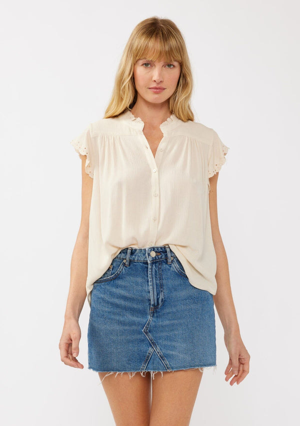 [Color: Shell] A front-facing image of a blonde model wearing a light yellow crinkled rayon top. The top features flutter sleeves with eyelet details, a split V-neckline, and a button-front design, offering a versatile look for everyday wear.