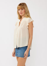 [Color: Shell] A side-facing image of a blonde model wearing a light yellow crinkled rayon top. The top features flutter sleeves with eyelet details, a split V-neckline, and a button-front design, offering a versatile look for everyday wear.