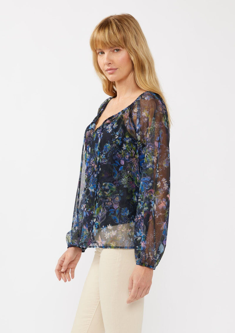 [Color: Black/Dusty Pink] A side facing image of a blonde model in a navy sheer micro mesh blouse with floral print, featuring long sleeves, tie-front detail, elastic cuffs, and cami lining; perfect for evening and casual chic styling.