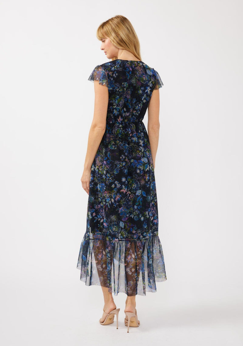 [Color: Black/Dusty Pink] A back facing image of a blonde model wearing a micro mesh flowy maxi dress with a navy blue floral print. This faux wrap dress features a flattering v-neckline, short flutter sleeves, and a ruffle trimmed hem. Perfect for special occasions, weddings, and formal dinners. 