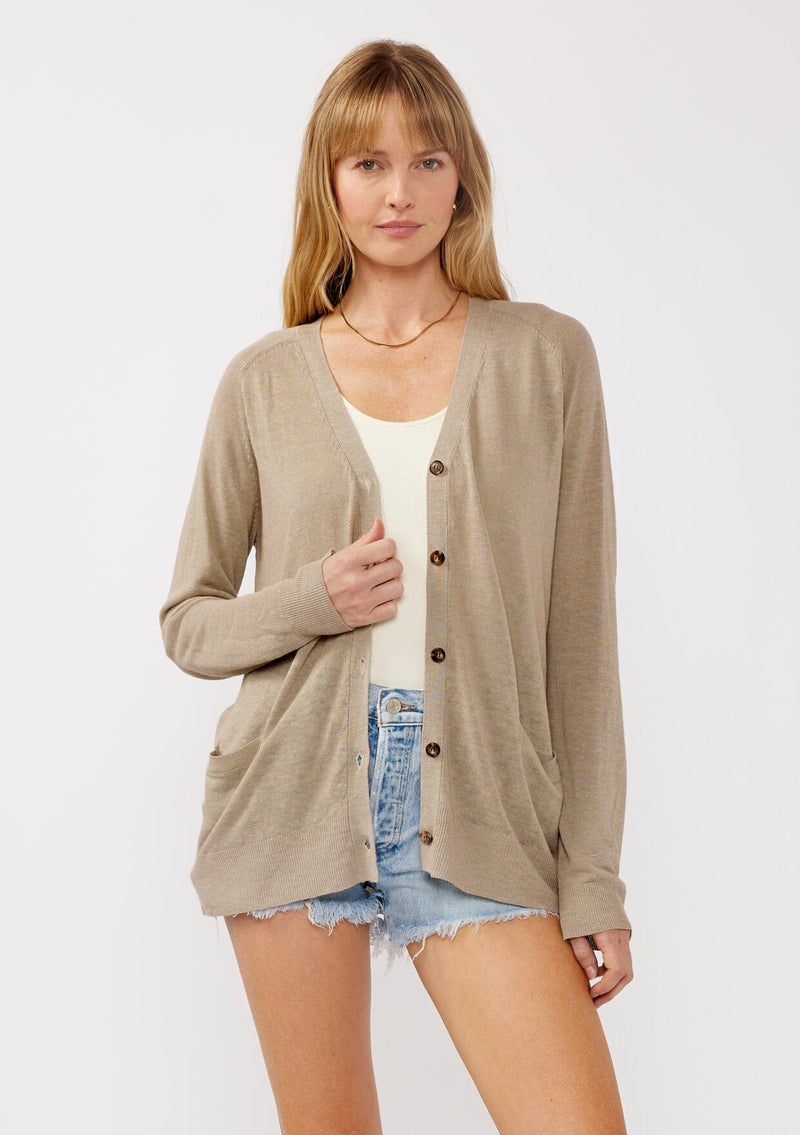 [Color: Taupe] A front facing image of a blonde model wearing a thin linen and viscose blend cardigan with long sleeves, a button front, and a v-neckline. An effortless basic throw on cardigan for the spring season. 