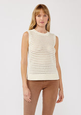 [Color: Ivory] A front facing image of a blonde model wearing an ivory sleeveless open knit sweater vest with a crew neckline, ribbed trim, and side slits. Perfect for layering over long sleeves or wearing on its own. 