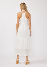 [Color: White] A back image of a blonde model wearing a bohemian-inspired white maxi dress featuring embroidered eyelet details and textured clip dots. The relaxed, tiered silhouette includes adjustable straps, a v-neckline, and a racerback design, making it ideal for beach days, weddings, or any special occasion.