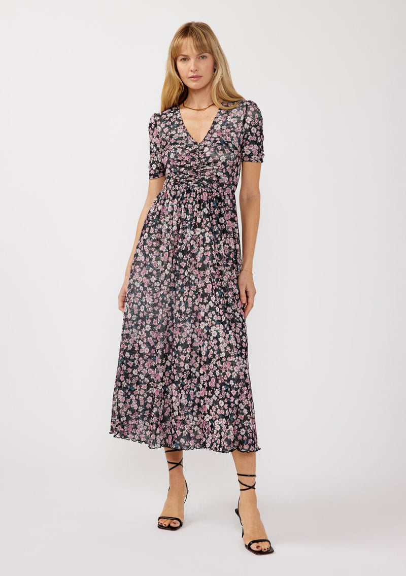 [Color: Black/Dusty Pink] A front facing image of a blonde model wearing a soft micro mesh reversible midi dress with pink floral print. Featuring a v-neckline, short sleeves, ruched bust, and a merrow edge hem. Perfect for spring styling and casual days. 