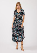 [Color: Black/Dusty Pink] A front facing image of a blonde model wearing a soft micro mesh reversible midi dress with blue floral print. Featuring a v-neckline, short sleeves, ruched bust, and a merrow edge hem. Perfect for spring styling and casual days. 