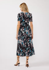 [Color: Black/Dusty Pink] A back facing image of a blonde model wearing a soft micro mesh reversible midi dress with blue floral print. Featuring a v-neckline, short sleeves, ruched bust, and a merrow edge hem. Perfect for spring styling and casual days. 