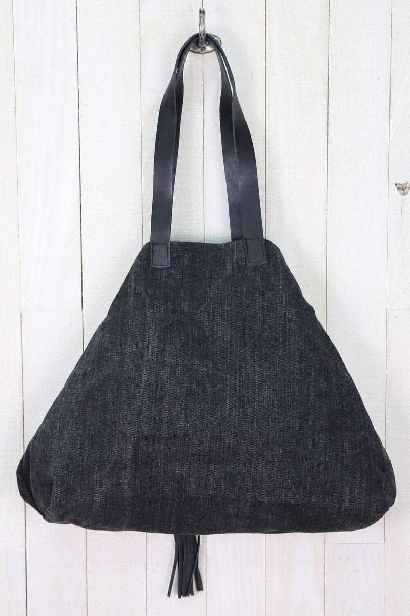 [Color: Nero/Nero] A large  black cotton tote bag with contrasting leather accents, featuring a spacious design, swivel hook for easy compression, and a stylish tassel detail.