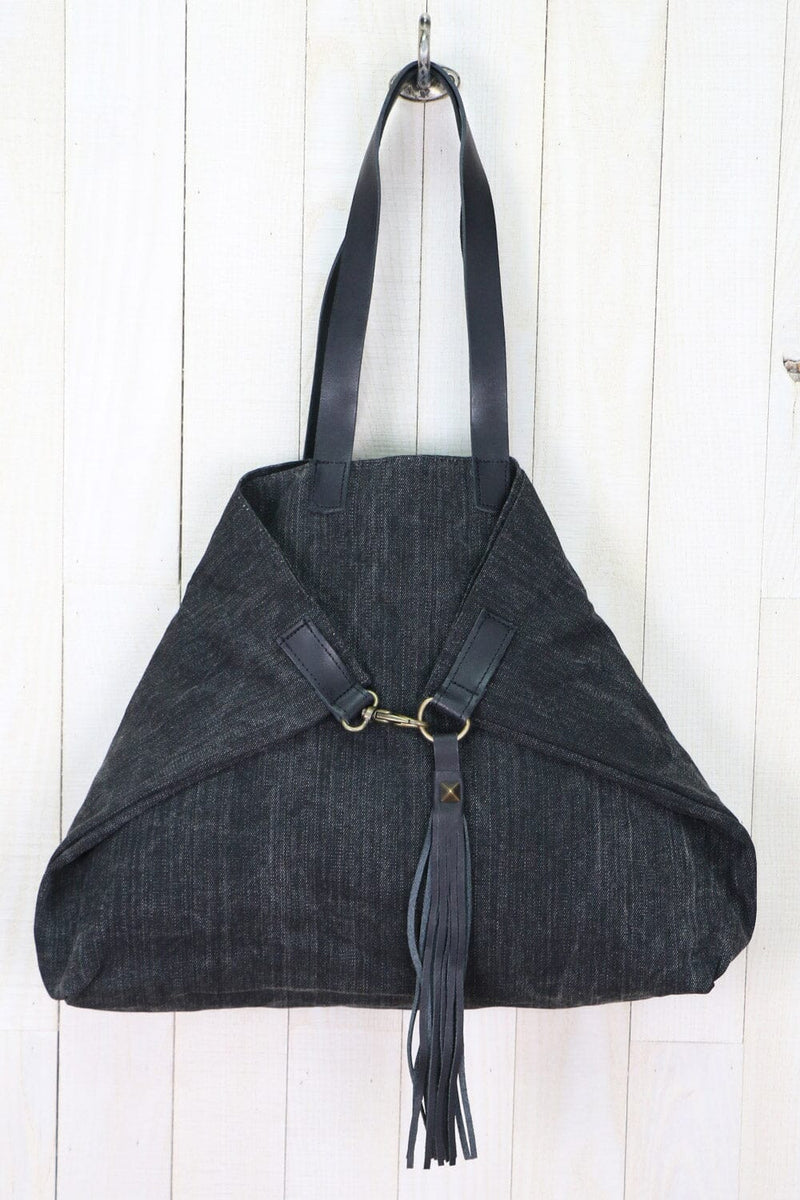 [Color: Nero/Nero] A large  black cotton tote bag with contrasting leather accents, featuring a spacious design, swivel hook for easy compression, and a stylish tassel detail.