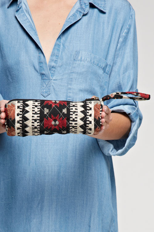 [Color: Black Combo] An image of a small makeup bag with a southwestern tribal pattern and wristlet strap. Perfect as a traveling essential and staying organized. 