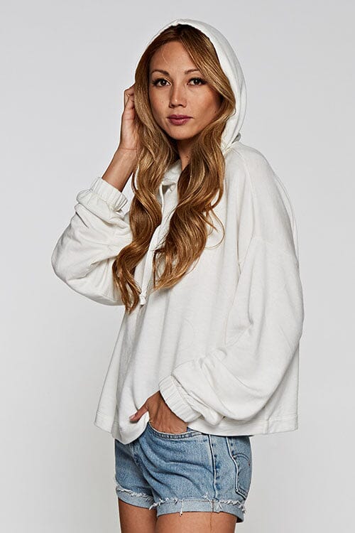 [Color: Off White]  A blonde model wearing a solid white pullover hoodie with a drawstring hood, long sleeves, and dropped shoulders. The cropped length makes it perfect for lounging, travel, or casual fall outings.