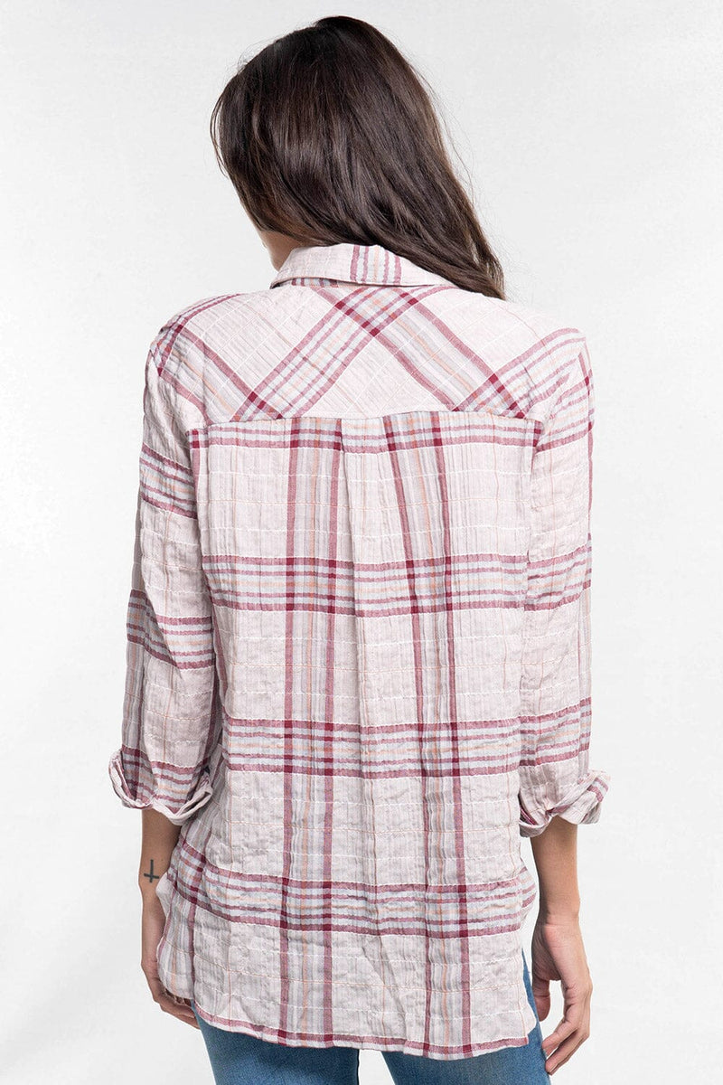 [Color: Taupe/Grey/Burgundy] A back facing image of a  brunette model wearing a wine red plaid button down shirt with a classic collar neckline, roll tab sleeves, and a high low hemline. 