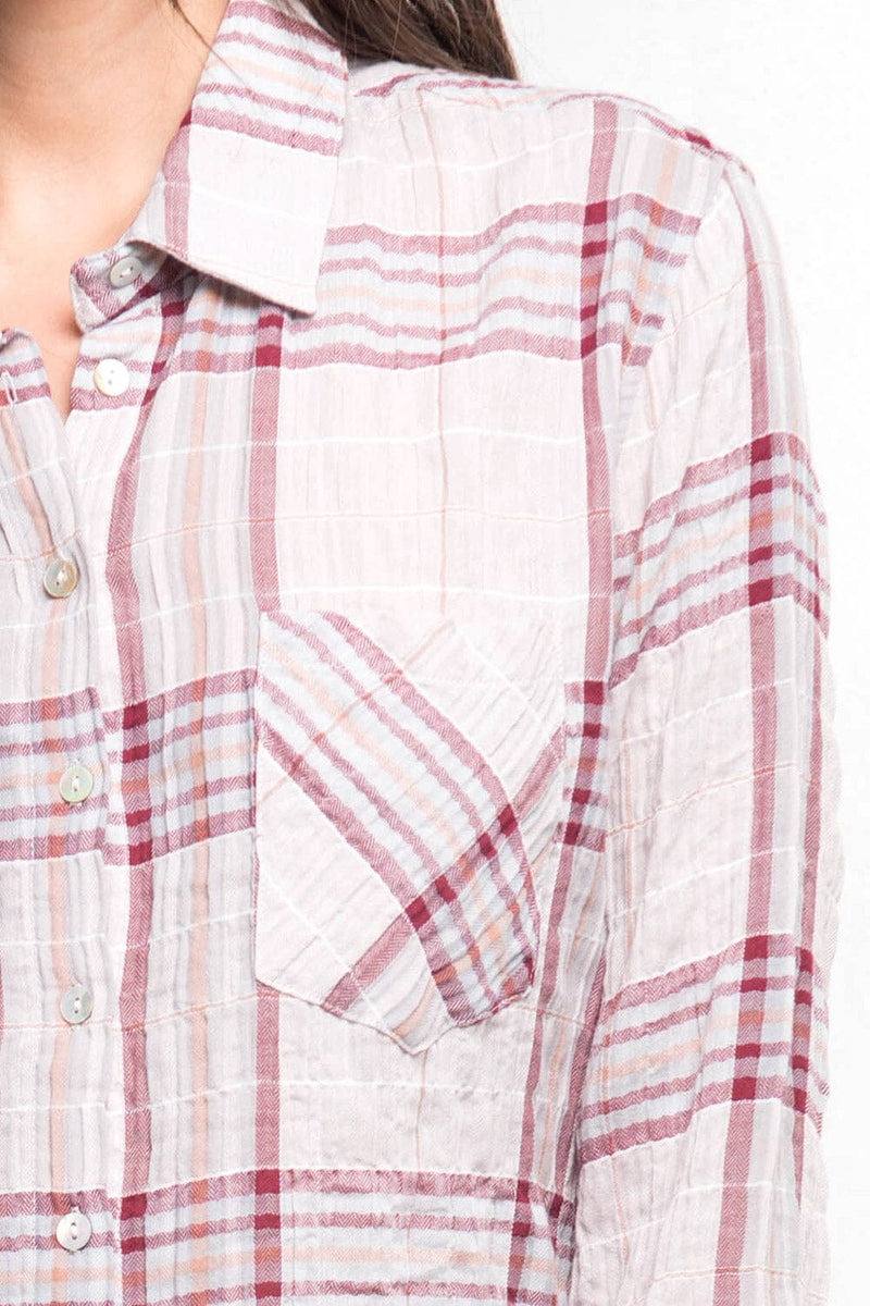 [Color: Taupe/Grey/Burgundy] A detail image of a brunette model wearing a wine red plaid button down shirt with a classic collar neckline, roll tab sleeves, and a high low hemline. 