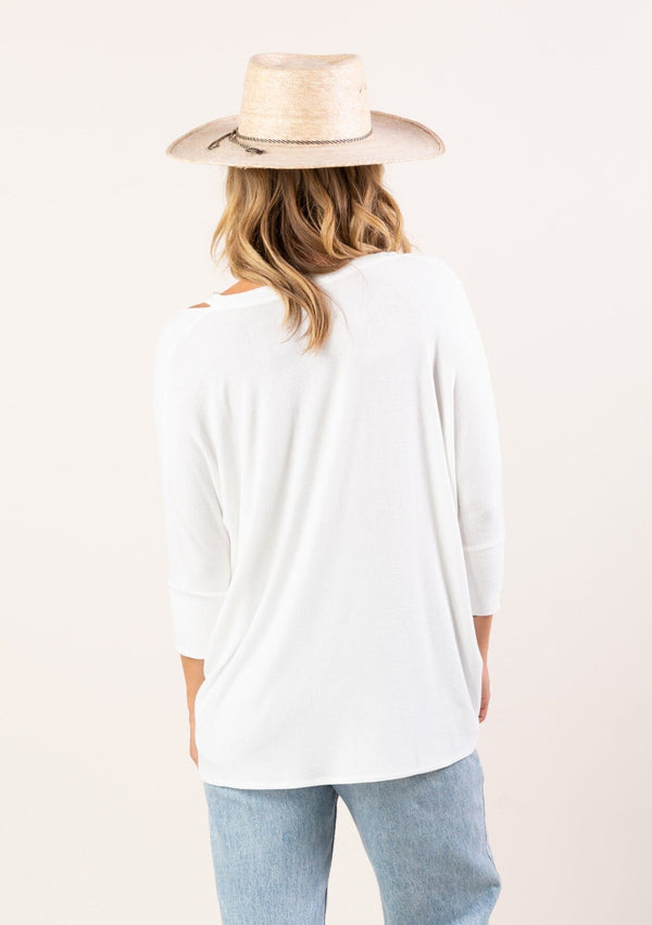 [Color: White] A blonde model wearing an ultra soft bamboo knit tee. This micro rib top features 3/4 length sleeves, a v-neckline, and cutout shoulder details. A basic essential for any season. 