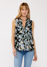 [Color: Black/Pale Blue] A front facing image of a blonde model wearing a black and blue floral print blouse sleeveless top. Featuring a button front and a split v neckline with a ruffle trim detail. Perfect for work and special occasions. 