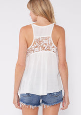 [Color: Vanilla] A casual warm weather top. This tank top features a swing silhouette, crochet lace details, twist strap, and scoop neckline. The perfect breathable top for the summer season.