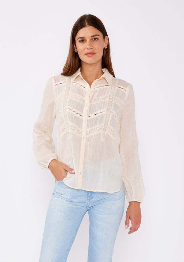 [Color: Light Peach] An image of a brunette model wearing a sheer nude peach color bohemian shirt. With long sleeves, a collared neckline, a self covered button front, and lace trim.