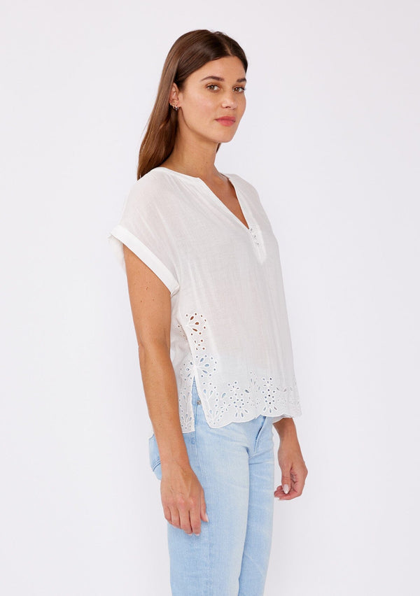 [Color: White] A brunette model wearing a white sheer top with a split v neckline and short dolman sleeves. A casual summer top with an embroidered eyelet detail at the hem with a 3 button front closure.