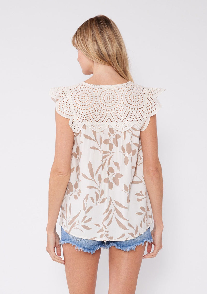 [Latte/Natural] A unique, bohemian chic white summer top featuring structured cap sleeves with lace detail, tan botanical print, split v neckline and scallop lace yoke and back detail. A bohemian chic summer top, perfect for any warm weather occasion.