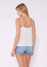 [Color: Off White] A flirty lace trim tank top for the summer. A casual top with a v neckline, adjustable spaghetti straps, lace trim inserts, and a ruffle trimmed hem. A perfect everyday white tank top paired with denim shorts.