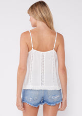 [Color: Off White] A flirty lace trim tank top for the summer. A casual top with a v neckline, adjustable spaghetti straps, lace trim inserts, and a ruffle trimmed hem. A perfect everyday white tank top paired with denim shorts.