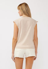 [Color: Buff] A back facing image of a blonde model wearing a taupe rayon and cotton blend top with an embroidered floral cutout design. This casual spring top features a v neckline, button front, short dolman sleeves, and a hip hugging elastic hem at the back. 