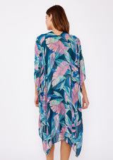 [Color: Teal/Dusty Orchid] A brunette model wearing a blue and pink tropical inspired palm leaf print kimono. A lightweight kimono perfect for the beach or to style a casual outfit. With an open front, mid length , half kimono sleeves, and side vents.